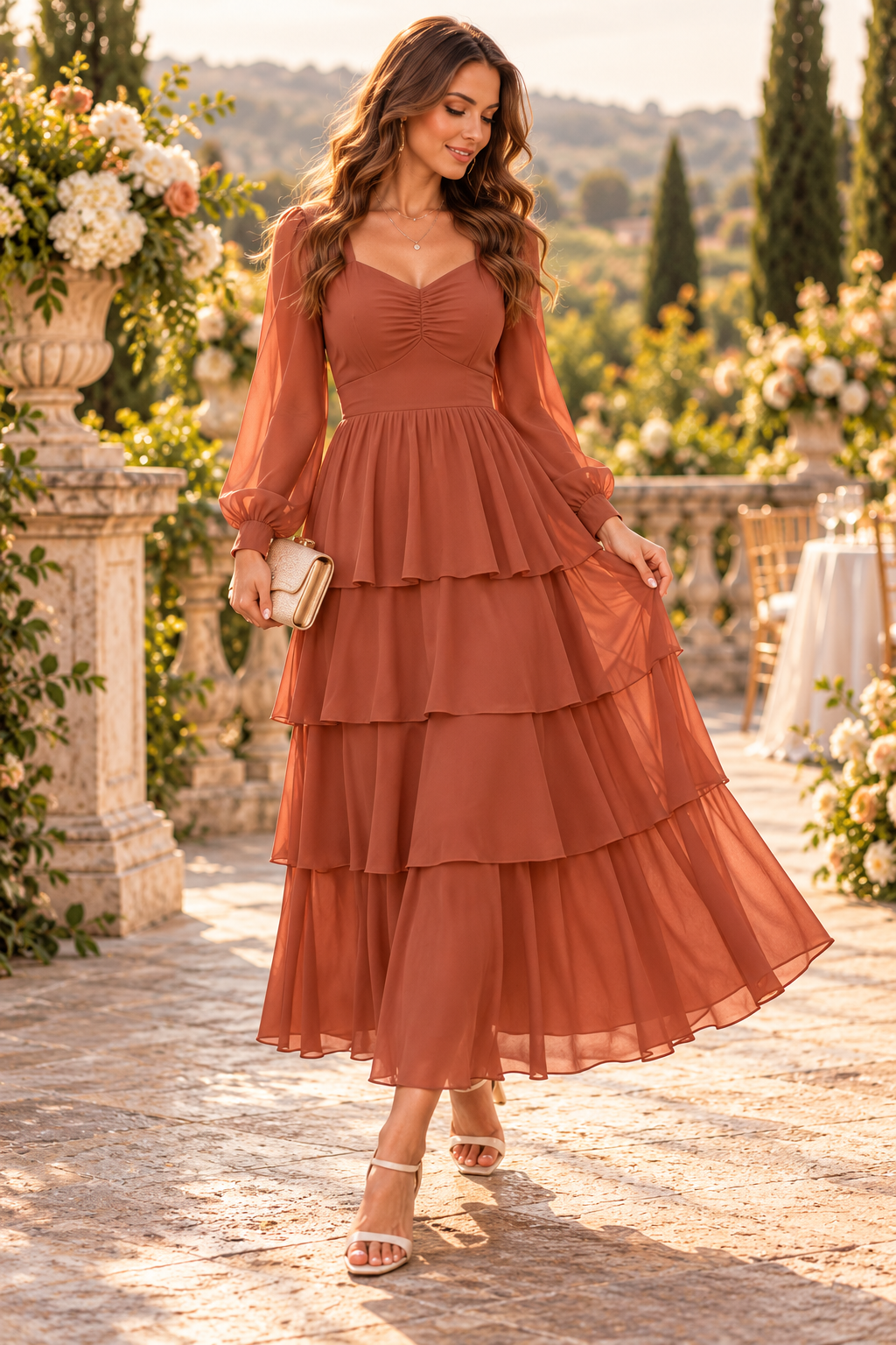 Woman in a terracotta tiered dress holding a clutch in a sunlit garden